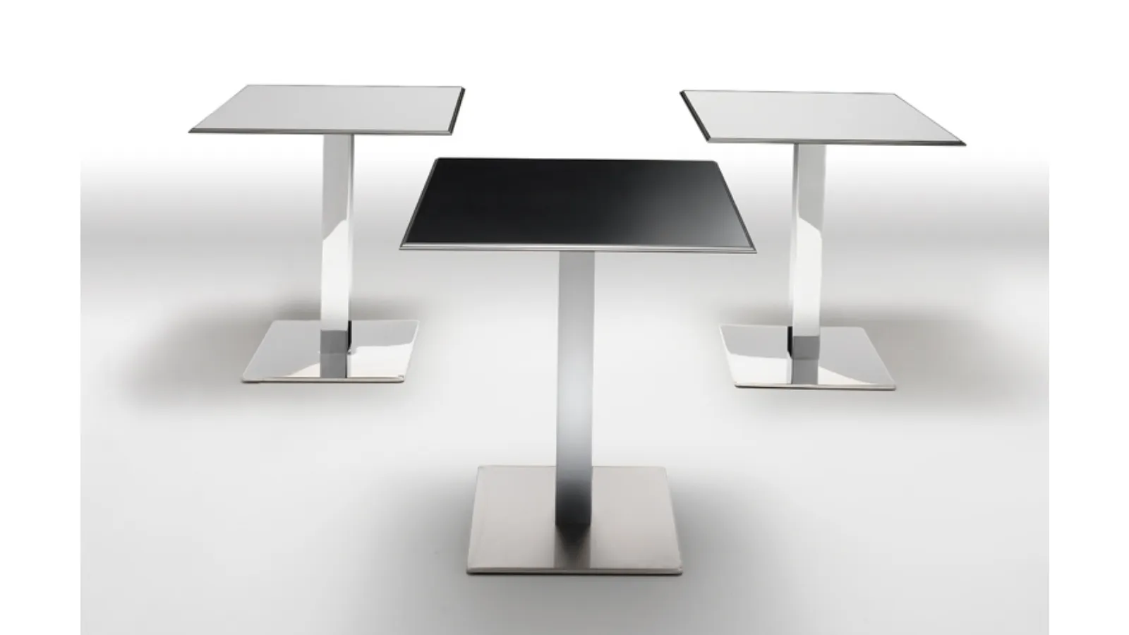 Plano Table by Infiniti with laminate top and chromed steel base.