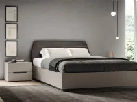 Soft bed with padded headboard by Spagnol Mobili.