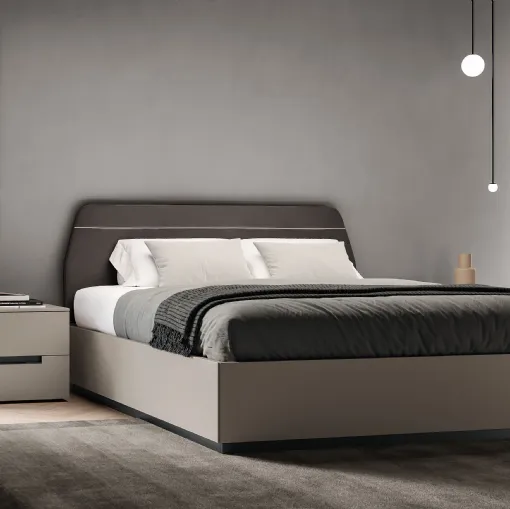 Soft bed with padded headboard by Spagnol Mobili.