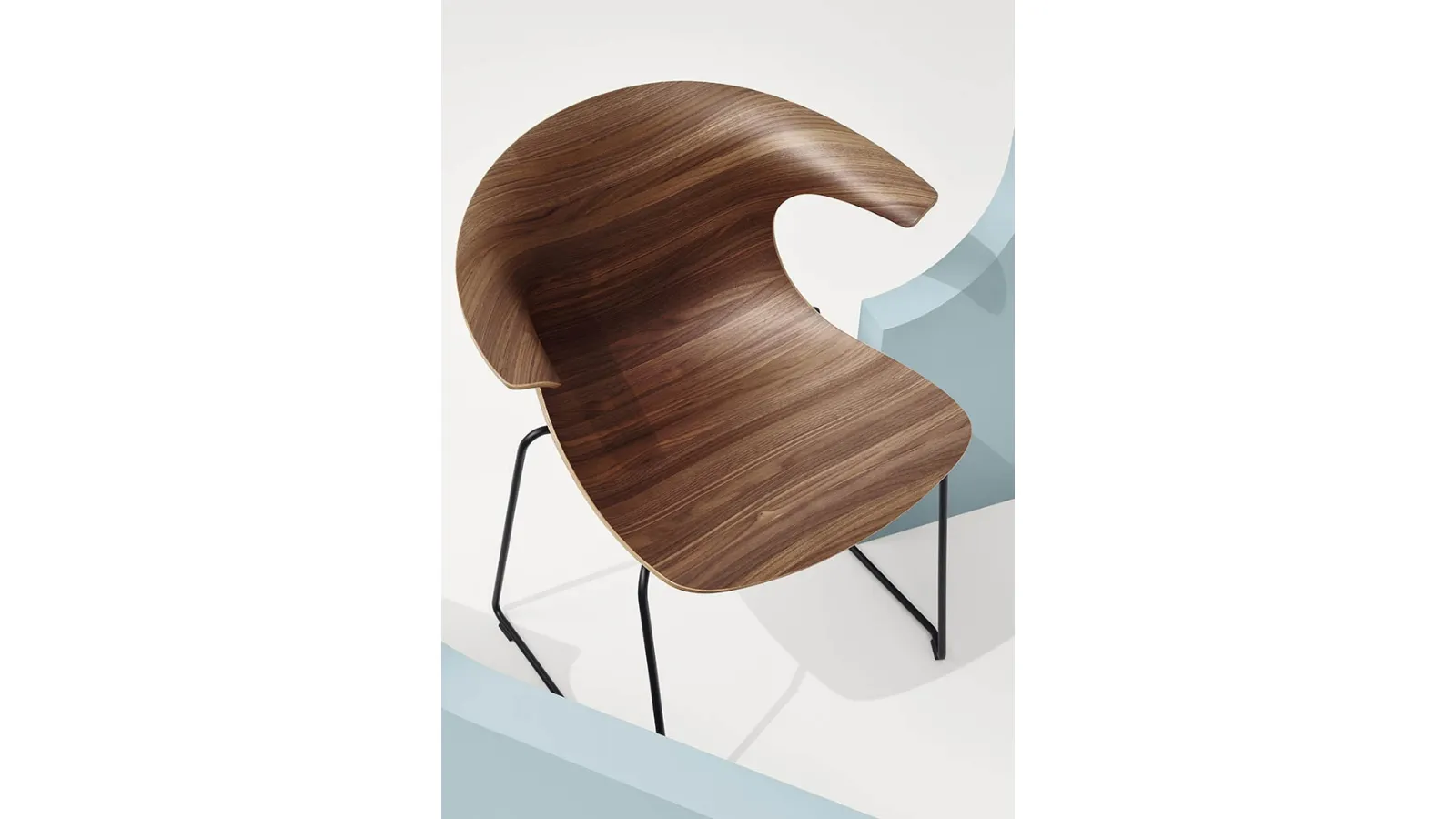 Loop 3D Wood Sled Chair with wooden shell and steel sled base by Infiniti.