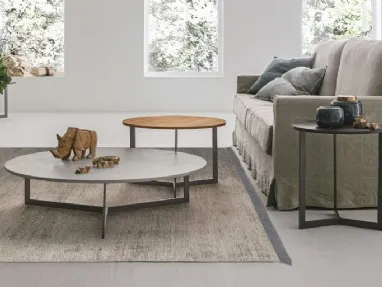 Round coffee table with textured Joy top by Tomasella.