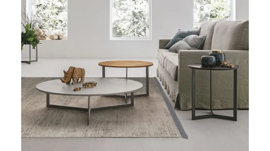 Round coffee table with textured Joy top by Tomasella.