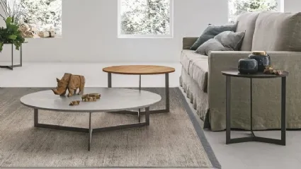 Round coffee table with textured Joy top by Tomasella.